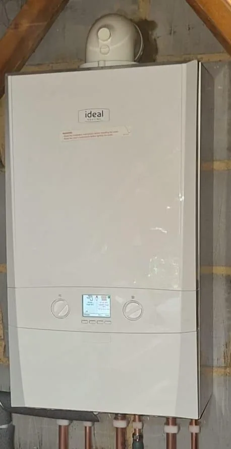 Ideal boiler and flue installed in a loft space by a Gas Safe registered engineer